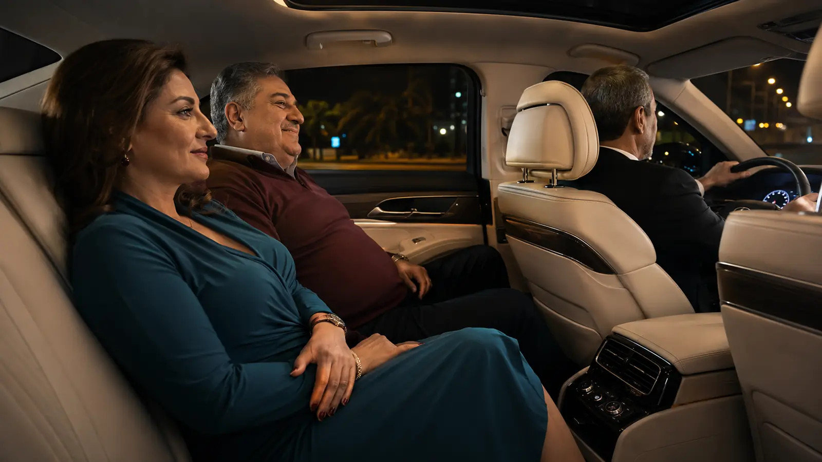 Couple relaxing in the back seat while a private driver handles their dinner transportation.